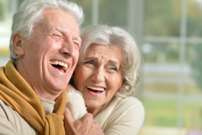 portrait of a happy laughing senior couple at home